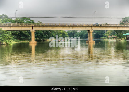 Road bridge across the lake in forests Stock Photo