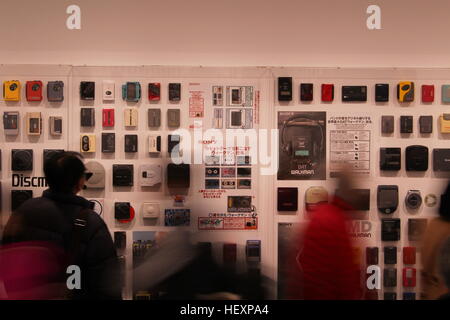 Visitors look at a display of Sony Walkman portable cassette players at an exhibition in the Sony Building in Ginza. 12/2016. Stock Photo