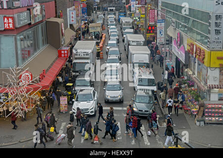 Intersection of Main Street and 40th road in Chinatown, downtown Flushing, New York City. Crowded with cars & crowded with people. Stock Photo