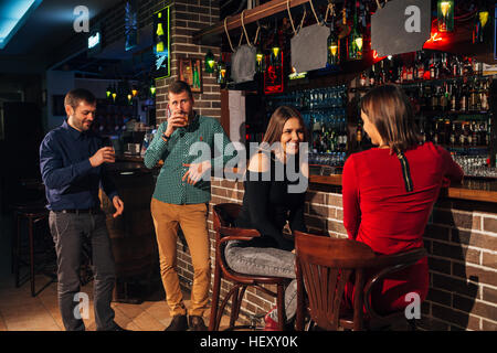 two of the men in the bar he meets  women Stock Photo