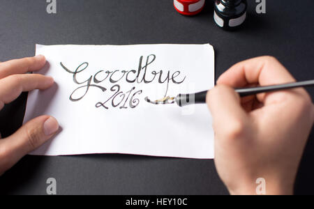 calligraphy writting a goodbye 2016 card in ink Stock Photo
