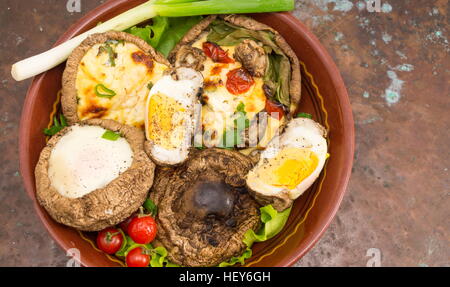 egg and cheese stuffed mushrooms on a vintage background Stock Photo