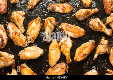 bbq chicken wings on a black baking plate Stock Photo