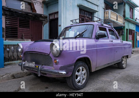 Purple painted Ford Consul car with many repairs to the bodywork, Baracoa, Cuba Stock Photo