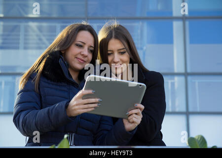 Two young business women with a tablet in hand Stock Photo
