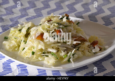 Salad with cabbage and mushrooms on a white plate Stock Photo