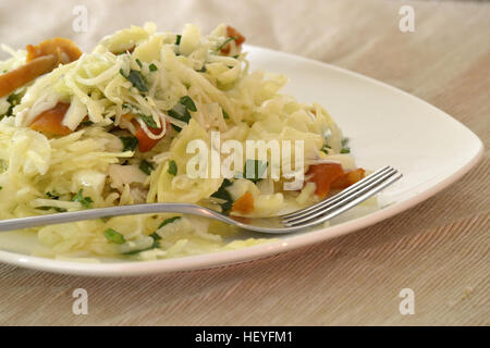 Salad with cabbage and mushrooms on a white plate Stock Photo