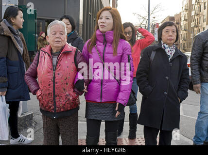 Asian women walking arm in arm on Main Street in Chinatown, downtown Flushing, Queens New York Stock Photo
