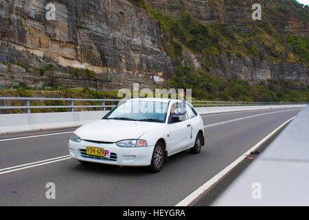 Clifton, Australia - 18th December 2016:  The Sea Cliff Bridge is a balanced cantilever bridge located in the northern Illawarra region of New South Wales. The bridge valued at $52 million links the coastal suburbs of Coalcliff and Clifton together. Pictured are people driving across the bridge. Stock Photo
