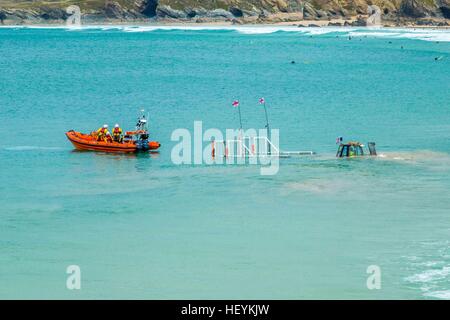 The Newquay RNLI life boat returning to the harbour in Cornwall on it;'s cradle Stock Photo