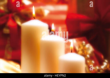 Three white burning candles, lit candles Stock Photo