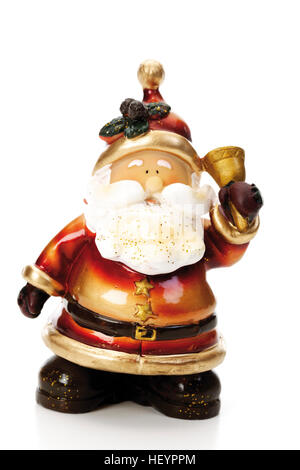 Santa Claus figurine ringing a golden bell, Christmas decoration Stock Photo
