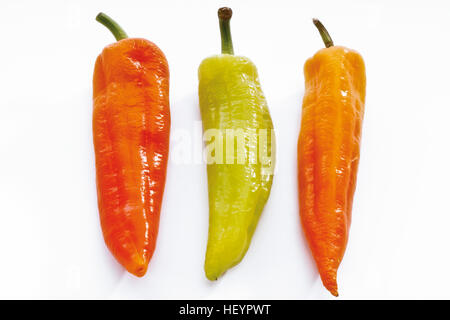 Three hot peppers, green, orange and red Stock Photo