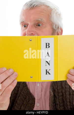 Retiree, senior looking through his bank account transactions, shocked Stock Photo