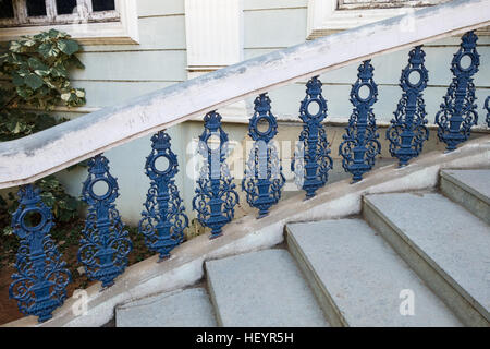Modern blue wrought iron railing with stone steps Stock Photo