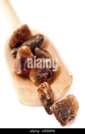Brown rock candy (sugar candy) on a wooden spatula Stock Photo
