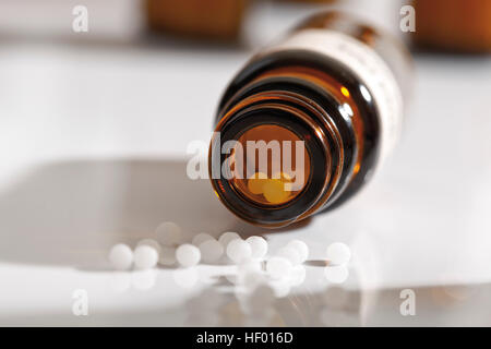 Homeopathic medicine, globules, granules in a bottle Stock Photo
