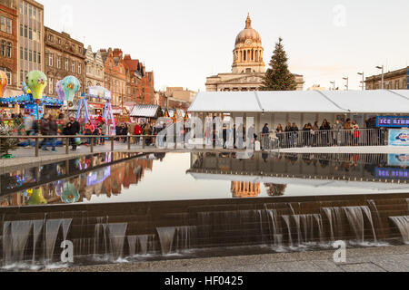 Various people at Nottingham Christmas Market and temporary ice rink. In Nottingham, England. Stock Photo