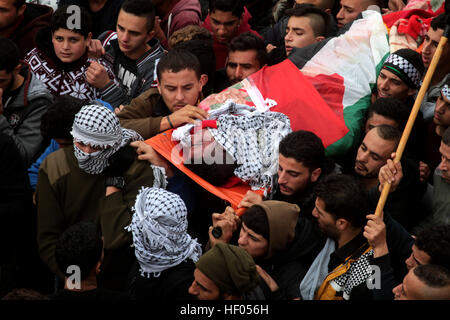Jenin, West Bank, Palestine. 24th Dec, 2016. Palestinians carry the body of Mohammed Turokman, 23, during his funeral at the Qabatya village, near the West Bank City of Jenin, 24 December 2016. His body shortly before was handed over by Israel to Palestinian authorities. Turokman A Palestinian policeman was killed by Israeli forces after he committed a shooting attack near Ramallah on 31 October 2016 injuring three Israeli soldiers. © Mohammed Turabi/ImagesLive/ZUMA Wire/Alamy Live News Stock Photo