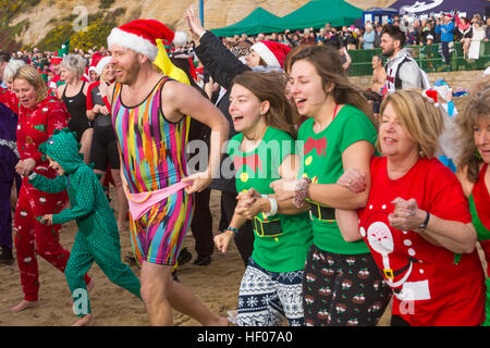 Bournemouth, Dorset, UK. 25th Dec, 2016. Christmas Day 25th December 2016. White Christmas Dip at Boscombe, Bournemouth, Dorset, UK. Brave volunteers plunge into the cold choppy sea for a swim, for the 9th annual charity Christmas morning swim, dressed in fancy dress costumes and raising money for Macmillan Caring Locally at Christchurch, a Specialist Palliative Care Unit for patients in the local community. Hundreds take part in the event which has become a popular tradition for many before their lunch. © Carolyn Jenkins/Alamy Live News Stock Photo