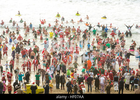 Bournemouth, Dorset, UK . 25th Dec, 2016. Christmas Day swimmers take to the sea at Boscombe, Bournemouth, UK 25 December 2016 © John Beasley/Alamy Live News Stock Photo