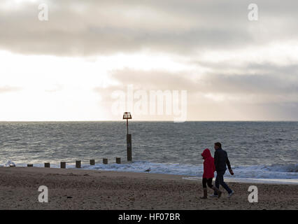 Boscombe, Bournemouth, Dorset, UK. 25th Dec, 2016. UK weather: Choppy seas at Boscombe beach - couple enjoy a walk along the seashore on Christmas Day © Carolyn Jenkins/Alamy Live News Stock Photo