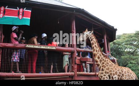 Nairobi, Kenya. 25th Dec, 2016. Tourists visit the Giraffe Center in Nairobi, capital of Kenya, Dec. 25, 2016. Giraffe Center, founded in 1979, is part of a movement trying to save giraffes, with some giraffe species currently endangered. © Li Baishun/Xinhua/Alamy Live News Stock Photo