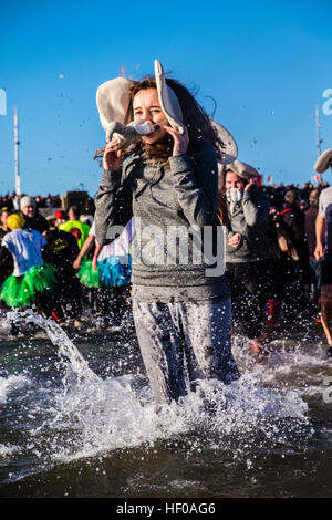 Hardy souls take to the North Sea in fancy dress in Sunderland's annual Boxing Day Dip. The dip is arranged by the Sunderland Lions Club and raises money for charity. (c) Paul Swinney/Alamy Live News Stock Photo