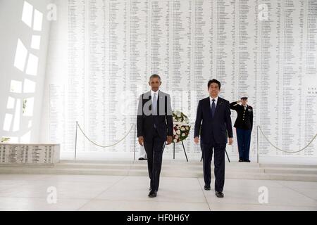 Pearl Harbour, Hawaii. 27th Dec, 2016. U.S President Barack Obama and Japanese Prime Minister Shinzo Abe walk together following a wreath laying at the USS Arizona Memorial December 27, 2016 in Pearl Harbor, Hawaii. Abe is the first Japanese leader to publicly view the site of the Pearl Harbor Attack. Credit: Planetpix/Alamy Live News Stock Photo