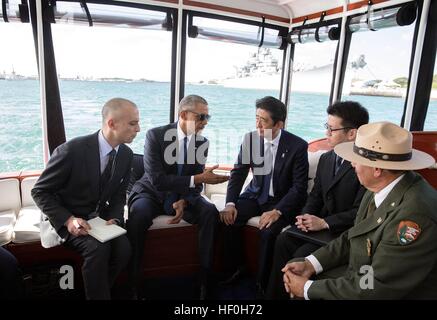 Pearl Harbour, Hawaii. 27th Dec, 2016. U.S President Barack Obama and Japanese Prime Minister Shinzo Abe travel aboard the Commanders boat to the USS Arizona Memorial December 27, 2016 in Pearl Harbor, Hawaii. Abe is the first Japanese leader to publicly view the site of the Pearl Harbor Attack. Credit: Planetpix/Alamy Live News Stock Photo
