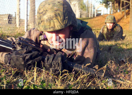 041026-M-7660L-052 Camp Warrior, Korea (Oct. 26, 2004) Ð Staff Sgt. Jesus Rivera, assigned to the 9th Engineer Support Battalion (ESB), low crawls during the combat conditioning for the Marine Corps Martial Arts Program tan belt sustainment training at Camp Warrior, Korea. The Marines and Korean Military are participating in Korean Incremental Training Program 05-1 (KITP). KITP is a three-prong exercise, with the focus on engineer training, medical training and the interoperability with the host nation. U.S. Marine Corps photo by Chief Warrant Officer Two Timothy E LeMaster (RELEASED) US Navy  Stock Photo