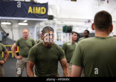 Cpl. Steven L. Mendez, 31, from Riverside, Calif., with Military Police Company, Combat Logistics Regiment 17, tries to intimidate his sparring partner during a mechanical advantage control hold exercise aboard the USS Bonhomme Richard, Sept. 30. Confidence and intimidation play a big role in getting suspects to cooperate. Mechanical advantage control holds are the methods MPs use to detain a suspect through joint manipulation and pain compliance. MPs brush up on takedowns aboard USS Bonhomme Richard DVIDS466915 Stock Photo