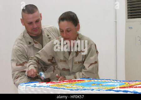 070303-M-6339F-009 CAMP FALLUJAH, Iraq (March 3, 2007) Ð Sailors help themselves to birthday cake at Hope Chapel in honor of the Seabee's 65th birthday. Marines and Sailors assigned to the 18th Builders Shop and II Marine Expeditionary Force (MEF) attended the ceremony. The 3rd Naval Construction Regiment and the II MEF is deployed in support of the global war on terrorism in the Al Anbar Province of Iraq. U.S Marine Corps photo by Lance Cpl. Sarah Furrer (RELEASED) US Navy 070303-M-6339F-009 Sailors help themselves to birthday cake at Hope Chapel in honor of the Seabee's 65th birthday Stock Photo