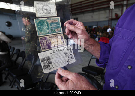 Tim Stanton, a San Gabriel, Calif., native and former Marine, displays $1.50 in “military money,” a Geneva Conventions card and an American propaganda leaflet at the 50th anniversary celebration for Marine Medium Helicopter Squadron 364 aboard Marine Corps Air Station Camp Pendleton, Calif., Nov. 10. Stanton had these items in his pockets when he was medically evacuated from Vietnam in 1971 by the HMM-364 Purple Foxes. Purple Foxes celebrate end of OIF, 50th anniversary 111110-M-NF414-386
