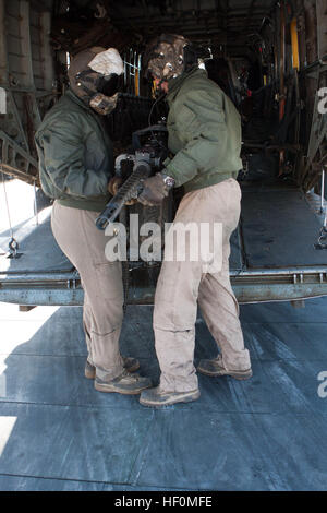 U.S. Marines Cpl. Zachary Hughes (left) and Lance Cpl. Madison DeLoach, crew chiefs, Marine Heavy Helicopter Squadron 363 (HMH-363), remove a. 50-caliber aircraft machine gun to load gear onto a CH-53D Sea Stallion helicopter, Camp Bastion, Helmand Province, Afghanistan, Jan. 5, 2012. HMH-363 conducted flight operations in support of troops throughout the Helmand Province. (U.S. Marine Corps photo by Lance Cpl. Robert R. Carrasco/Released). Marine heavy lift helicopters in action over Afghanistan 120105-M-CL319-108