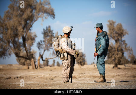 U.S. Marine Lance Cpl. Travis Finn, a mortarman with 2nd Platoon, Kilo Company, 3rd Battalion, 3rd Marine Regiment, and 23-year-old native of Erie, Pa., learns Pashto from Afghan National Policeman Abdul Salaam at a vehicle checkpoint near Patrol Base Amir Agha here, Jan. 12, 2012. After deploying to Helmand province’s Garmsir district in November 2011, Cpl. Reece Lodder, a combat correspondent with 3rd Bn., 3rd Marines, witnessed positive progress in Garmsir that has largely been ignored by mainstream media. He chronicled the work of Marines and sailors developing and advising Afghan forces t Stock Photo