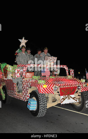 Soldiers from Joint Task Guantanamo ride atop a decorated Humvee during the holiday parade at U.S. Naval Station Guantanamo Bay, Cuba, Dec. 7, 2013. Dashing through the GTMO streets 131207-Z-IB888-014 Stock Photo