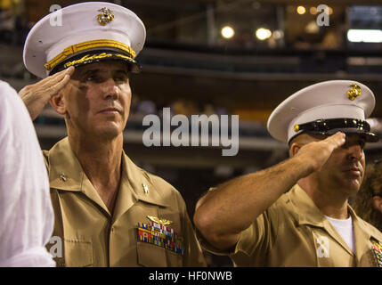 Col. John Farnam, left, the commanding officer of Marine Corps Air Station Miramar, and Sgt. Maj. Richard Charron, right, sergeant major of MCAS Miramar, salute during the National Anthem before a San Diego Padres at Petco Park, San Diego, Sept. 23. Farnam received the honor of throwing the first pitch of the game. Col. Farnam throws ceremonial first pitch 130923-M-RB277-060 Stock Photo