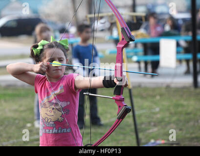 A child prepares to shoot a target at Tarawa Terrace Community Center March 8 during Outdoor Adventure's After School Archery Program. The program was aimed at children between the ages of 7 and 12. Kids take aim with after school archery program 120308-M-IY869-125 Stock Photo