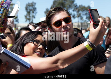 Zac Efron signed autographs and took photos with fans abroad Camp Pendleton before the premier release of his latest film, The Lucky One, at the base Bulldog Box Office movie theater, April 14. The young actor, best known for his role in The High School Musical trilogy, was accompanied by co-star Taylor Schilling and the film's director Scott Hicks. The Lucky One is scheduled for release April 20. Zac Efron at Marine Corps Base Camp Pendleton, CA Stock Photo