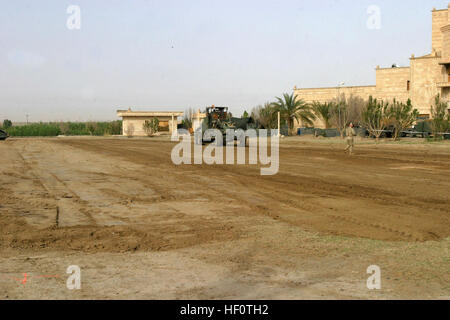 050422-M-8797S-022 Al Anbar Province, Iraq (April 22, 2005) Ð U.S. Navy Seabees level out the primary landing zone aboard Camp Blue Diamond so they are able to lay down metal plating to help prevent helicopters from kicking up dust when taking off or landing. Marines assigned to 2nd Marine Division conduct Security and Stabilization Operations (SASO) in the Al Anabar Province in support of Operation Iraqi Freedom  (OIF). U.S. Marine Corps photo by Cpl. Thomas Schaeffer (RELEASED) US Navy 050422-M-8797S-022 U.S. Navy Seabees level out the primary landing zone aboard Camp Blue Diamond so they ar Stock Photo