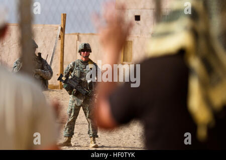 Soldiers of Company C, 4th Battalion, 118th Infantry Regiment, provide security while role players playing host-nation civilians shout demands for food and water during an embassy defense and evacuation exercise at Range 5 near Camp Buehring, Kuwait, May 29. The 4th Battalion's Company A conducted the same exercise at Range 5 three before. During the exercise, the infantry companies also coordinated with the 108th Assault Helicopter Battalion for rapid resupply and with Company C, 1st General Support Aviation Battalion, 126th Aviation Regiment to evacuate simulated wounded. The 4th Battalion b Stock Photo