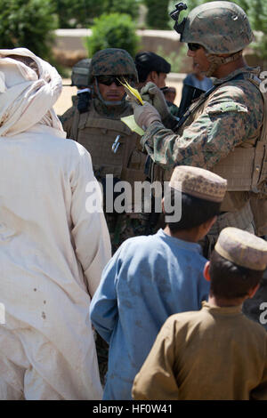 U.S. Marines Corps Sgt. Raymundo Luna, top right, a civil affairs noncommissioned officer with Delta Company, 1st Battalion, 7th Marine Regiment, Regimental Combat Team 6, speaks with local Afghan nationals during a patrol in Sangin, Helmand province, Afghanistan June 4, 2012. Luna spoke with several individuals from the surrounding villages to discuss the security of the village, as well as cooperation with Coalition Forces. (U.S. Marine Corps photo by Pfc. Jason Morrison/Released) 1-7 Marines patrol in Sangin 120604-M-TH715-109 Stock Photo