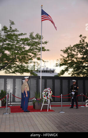 Staff Sgt. Aaron Goldin, ceremonial trumpeter and Marines with 3rd Battalion, 25th Marine Regiment, headquartered at Brook Park, take their post to conduct evening colors in front of the traveling Vietnam War memorial wall at Voinovich Park in Cleveland June 11 during Marine Week Cleveland.  Morning and evening colors will be conducted for the duration of Marine Week, which concludes June 17. More than 750 Marines are participating in Marine Week to commemorate the city's support for the military and celebrate community, country and Corps. Various displays showcase Marine Corps equipment, airc Stock Photo