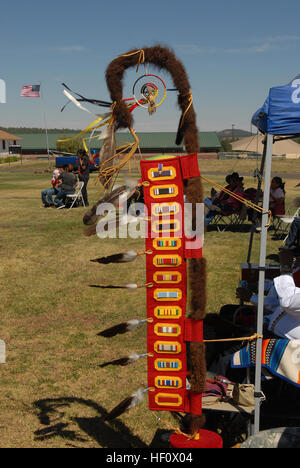 A photo of a clan or family war staff, also known as an Eagle Staff or Tscdettaan by the Natoh Diné Tachini, which was created by Jeffery Gay, represents and offers homage to fallen warriors of the clan. The staff was displayed during the third-annual Gourd Dance here, June 23. One side of the Eagle Staff displays all of the meritorious ribbons the clan members have received throughout the years in order of military precedence; including his grandfather's Indian Scout Ribbon, to honor the voluntary military service of the clan. War Staff represents Native American military service 120623-Z-kv6 Stock Photo