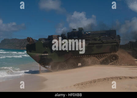 Marines from Combat Assault Company, 3rd Marine Regiment, launch an AAVP-7 amphibious assault vehicle into the water at Pyramid Rock Beach on July 12. More than 50 Marines with CAC, launched 13 AAVs to USS Essex and Special-Purpose Marine Air-Ground Task Force 3, as part of Rim of the Pacific 2012.  Because most amphibious assault ships are based out of San Diego, this is a rare opportunity for the Marines to work aboard a ship in Hawaii, according to 2nd Lt. Kyle Durant, AAV platoon commander with CAC. 'It prepares us for on- and off-ship and a lot of inter-service coordination,' Durant said. Stock Photo
