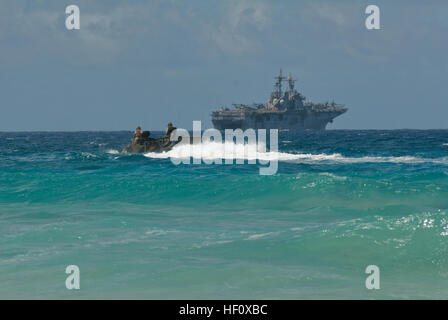 Marines from Combat Assault Company, 3rd Marine Regiment, steer their AAVP-7 amphibious assault vehicles to USS Essex (LHD 2) at Pyramid Rock Beach, July 12. More than 50 Marines with CAC, launched 13 AAVs to the USS Essex and Special-Purpose Marine Air-Ground Task Force 3, as part of Rim of the Pacific 2012.  Because most amphibious assault ships are based out of San Diego, this is a rare opportunity for the Marines to work aboard a ship in Hawaii, according to 2nd Lt. Kyle Durant, AAV platoon commander with CAC. 'It prepares us for on- and off-ship and a lot of inter-service coordination,' D Stock Photo