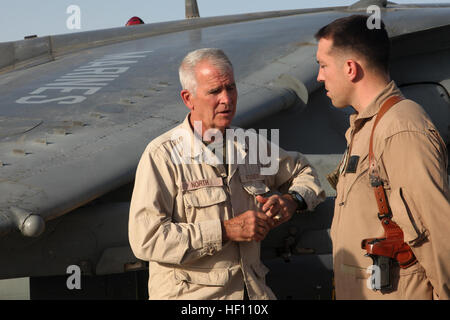 Retired U.S. Marine Lt. Col. Oliver North, Fox News reporter, interviews Marine Capt. Kevin T. Smalley, AV-8B Harrier pilot, Marine Attack Squadron (VMA) 211, Marine Aircraft Group 13, 3rd Marine Aircraft Wing (Forward)  at Camp Bastion, Helmand province, Afghanistan, Oct. 12, 2012. North was visiting Marines and conducting interviews about the attack on Sept. 14, 2012. (U.S. Marine Corps photo by Sgt. Keonaona C. Paulo/Released) Oliver North visits Marines in Afghanistan 121012-M-EF955-034 Stock Photo