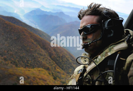 U.S. Air Force Tech. Sgt. Bobby Colliton, Survival Evasion Resistance and Escape specialist from the 18th Operation Support Squadron on Kadena Air Base, Japan, looks out of an HH-60 Pave Hawk after performing combat survival training with a 33rd Rescue Squadron aircrew member during Exercise Pacific Thunder 2012 near Osan Air Base, Republic of Korea, Oct. 15, 2012. Pacific Thunder is an annual two-week exercise that involves the 33rd and 31st RQS from Kadena AB, Japan, and the 25th Fighter Squadron from Osan. These units work together to practice combat search and rescue tactics to prepare for Stock Photo