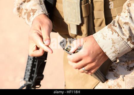 A U.S. Marine with 3rd Marine Aircraft Wing (Forward) loads a magazine with 5.56 rounds at Camp Leatherneck, Helmand province, Afghanistan, Oct. 19, 2012. He was preparing to conduct a battlefield zero to ensure his weapon functioned properly. 3rd MAW BZO 121019-M-EF955-040 Stock Photo